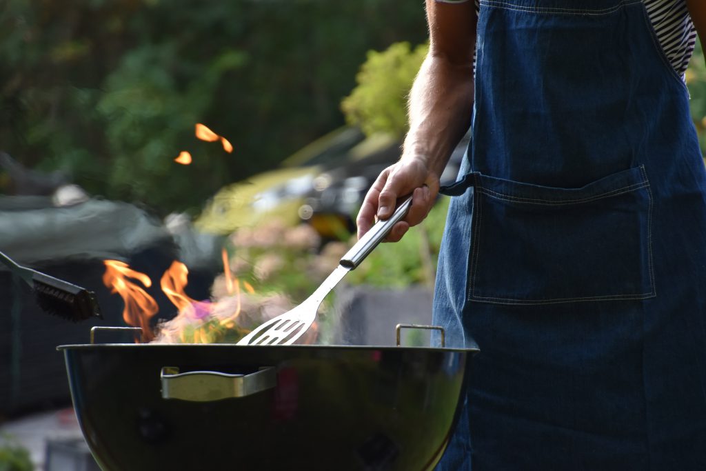 male cooking on BBQ